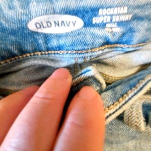 Old Navy junior skinny jeans with white bottom accent.